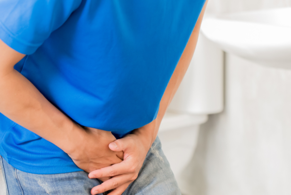 Person holding their pelvic area due to dysuria