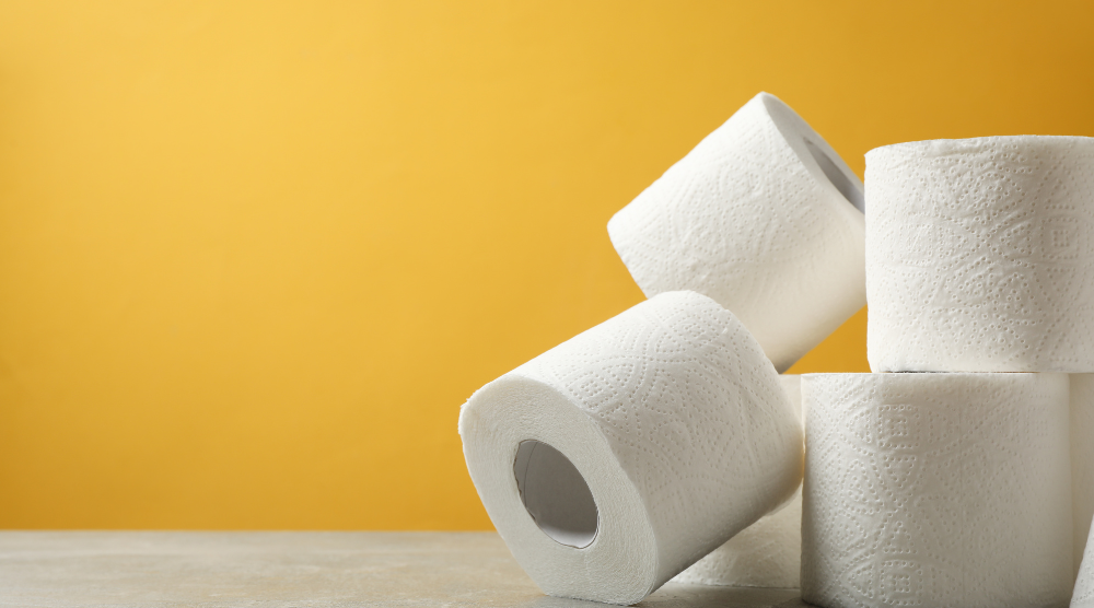 Rolls of toilet paper against a yellow background
